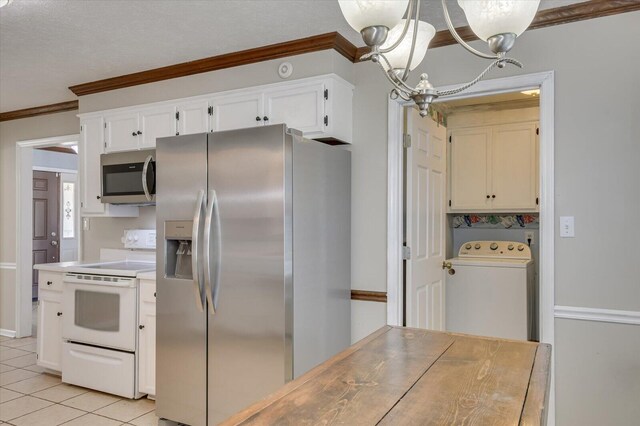 kitchen with washer / clothes dryer, white cabinetry, appliances with stainless steel finishes, light tile patterned flooring, and a chandelier