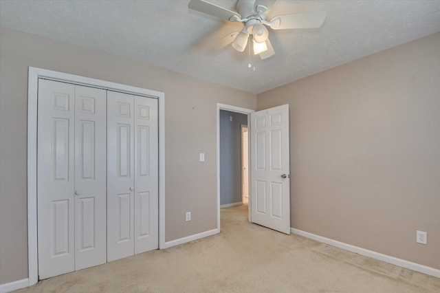 unfurnished bedroom with carpet, baseboards, a closet, and a textured ceiling