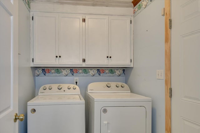 washroom with washer and dryer and cabinet space
