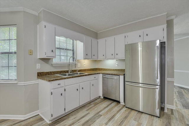 216 Dry Creek Rd, Evans, GA 30809 - kitchen featuring stainless steel appliances, a sink, dark countertops, light wood-type flooring, and white cabinets
