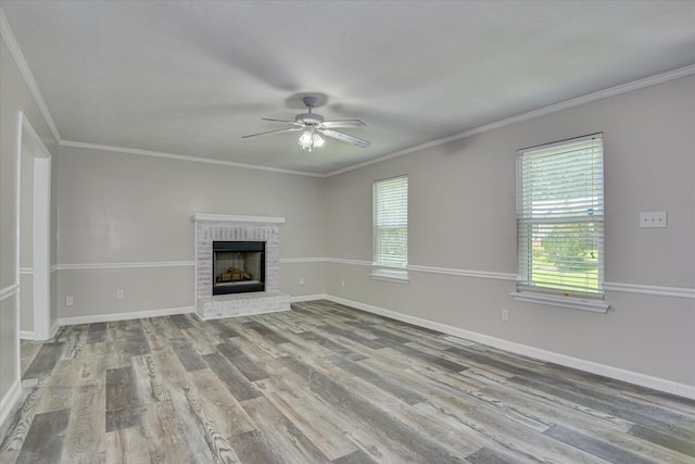 216 Dry Creek Rd, Evans, GA 30809 - unfurnished living room featuring wood finished floors, a ceiling fan, baseboards, a brick fireplace, and crown molding