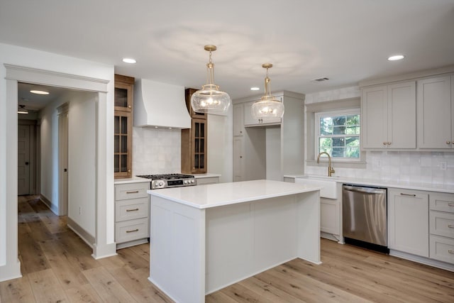 3313 Davant St, Augusta, GA 30907 - kitchen with dishwasher, custom range hood, decorative backsplash, light countertops, and glass insert cabinets