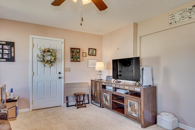 carpeted living room featuring ceiling fan