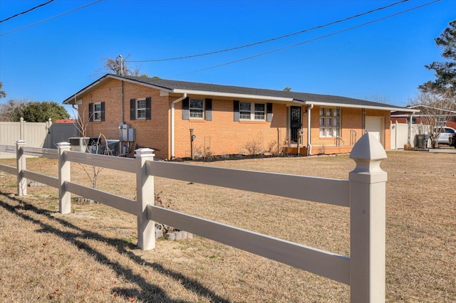 single story home with a garage and a front lawn