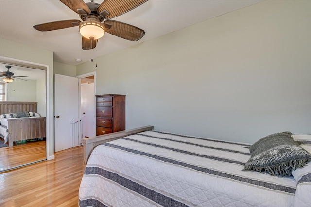 bedroom with ceiling fan, a closet, and hardwood / wood-style floors