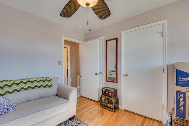 living area with ceiling fan and hardwood / wood-style floors