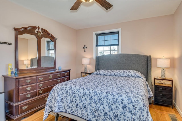 bedroom with ceiling fan and light wood-type flooring