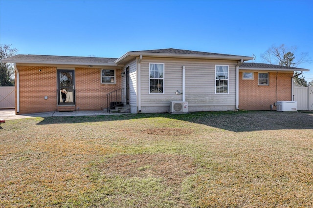 back of house with a lawn and ac unit