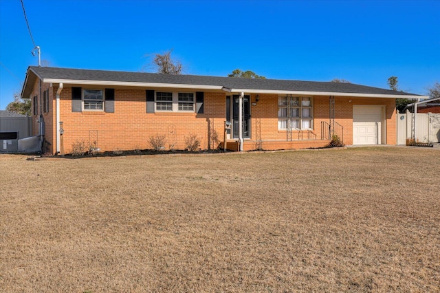 ranch-style home with a front yard and a garage