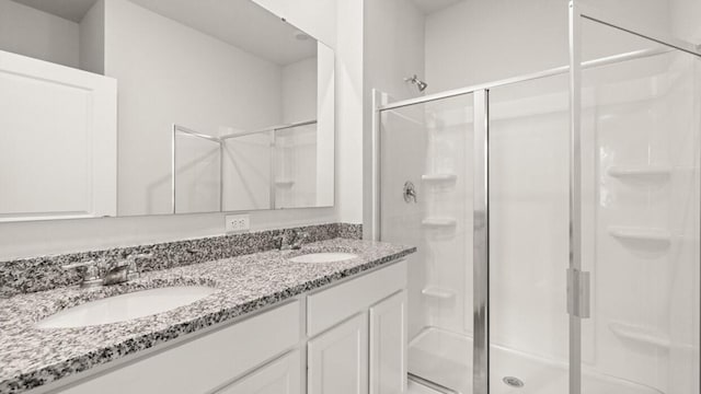 bathroom with walk in shower and vanity