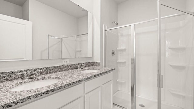 bathroom with an enclosed shower and vanity