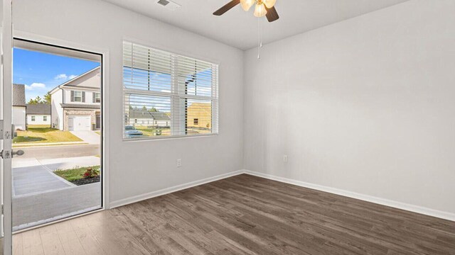 living room featuring ceiling fan and dark hardwood / wood-style floors