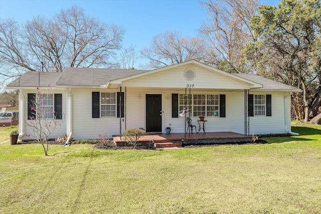 single story home featuring a porch, roof with shingles, and a front yard