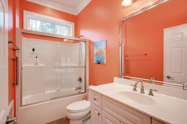 full bathroom featuring vanity, shower / bath combination with glass door, tile patterned flooring, toilet, and ornamental molding