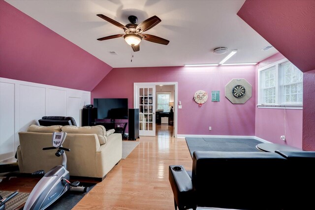 recreation room with ceiling fan, light hardwood / wood-style flooring, and vaulted ceiling