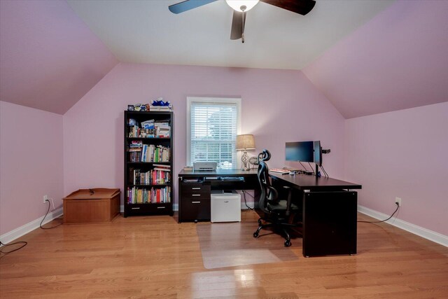 home office with vaulted ceiling, light hardwood / wood-style flooring, and ceiling fan