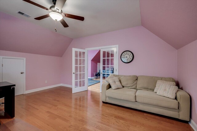 living room with french doors, light hardwood / wood-style floors, vaulted ceiling, and ceiling fan