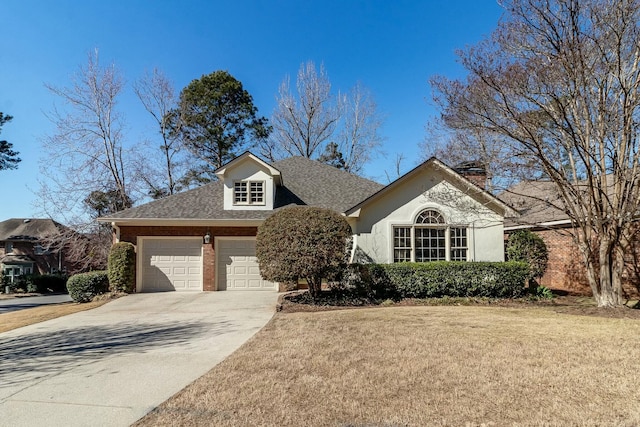 view of front facade featuring roof with shingles, brick siding, a garage, driveway, and a front lawn