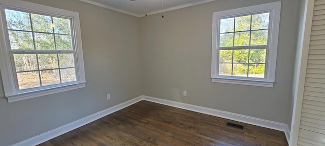 empty room with crown molding, dark wood-type flooring, and ceiling fan