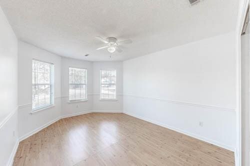 spare room featuring ceiling fan and light hardwood / wood-style floors