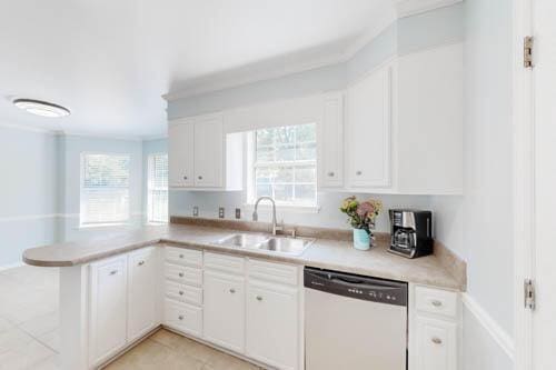 kitchen with white cabinetry, dishwasher, sink, kitchen peninsula, and light tile patterned floors