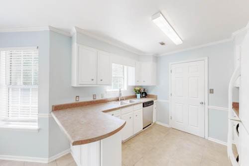 kitchen with white cabinets, stainless steel dishwasher, kitchen peninsula, and ornamental molding