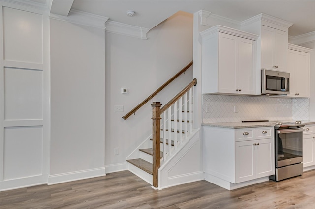 359 Sumac Trl, Evans, GA 30809 - kitchen featuring appliances with stainless steel finishes, crown molding, tasteful backsplash, light wood-style flooring, and white cabinets