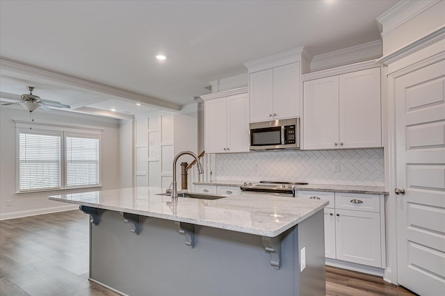 359 Sumac Trl, Evans, GA 30809 - kitchen with stainless steel appliances, a sink, backsplash, a kitchen island with sink, and a kitchen bar