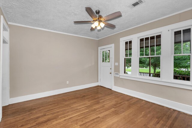 empty room with hardwood / wood-style flooring, ceiling fan, and ornamental molding