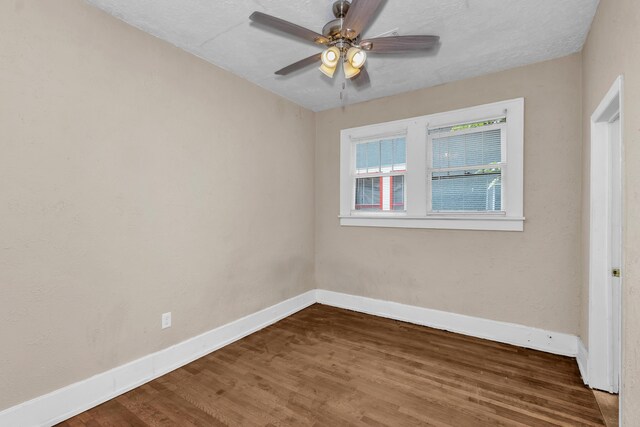 spare room with hardwood / wood-style floors, ceiling fan, and a textured ceiling