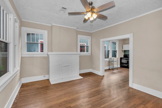 unfurnished living room featuring ceiling fan, crown molding, a textured ceiling, a fireplace, and hardwood / wood-style flooring