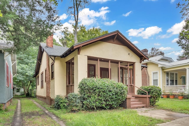 bungalow-style house with a sunroom