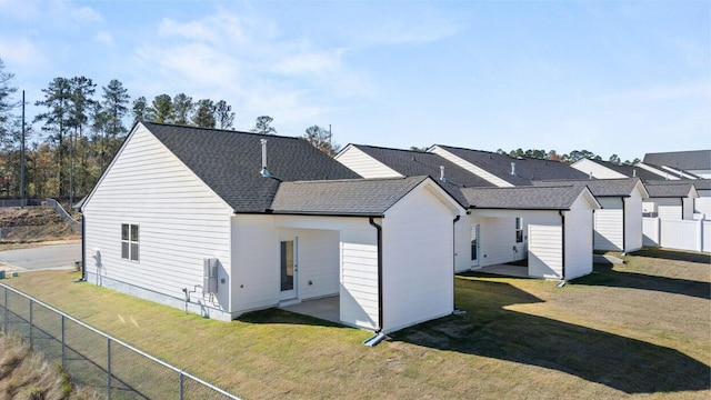 rear view of house with a lawn