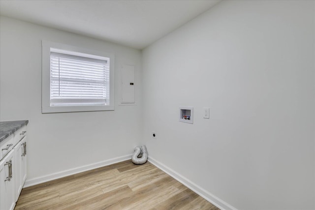 washroom featuring cabinets, electric panel, hookup for a washing machine, hookup for an electric dryer, and light hardwood / wood-style floors