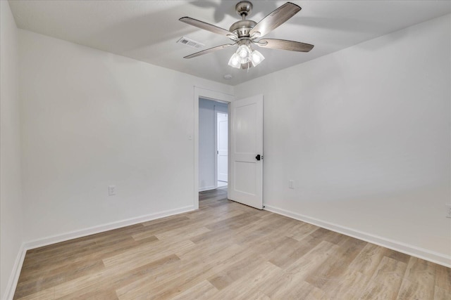 unfurnished room featuring visible vents, light wood-style flooring, a ceiling fan, and baseboards