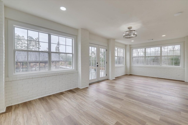 unfurnished sunroom with french doors