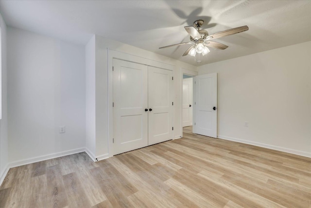 unfurnished bedroom with ceiling fan, a closet, baseboards, and light wood-style flooring