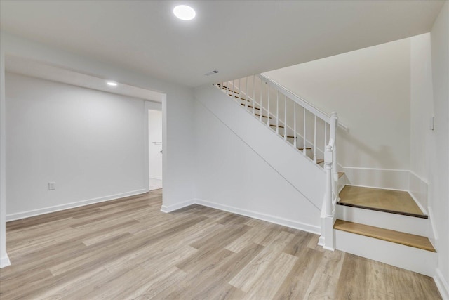 staircase with hardwood / wood-style flooring