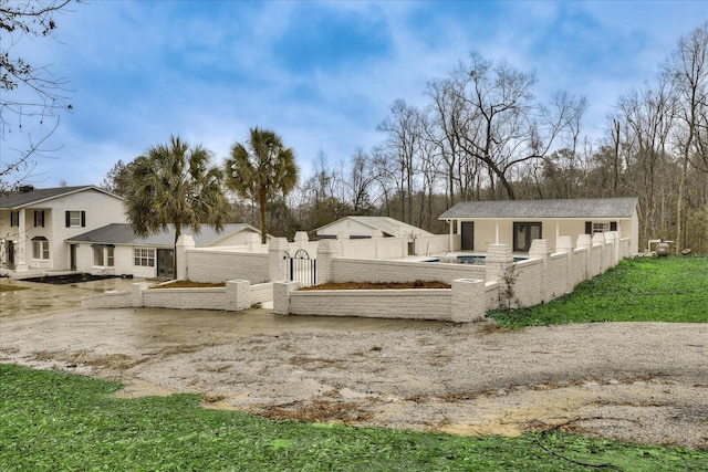 view of yard with an outbuilding, a swimming pool, and fence private yard