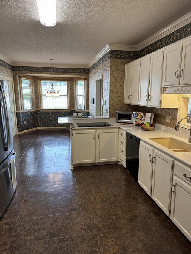 kitchen featuring crown molding, a sink, black appliances, a peninsula, and wallpapered walls