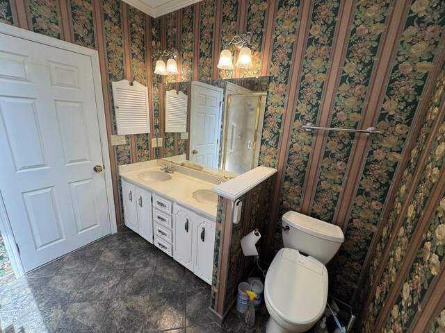 full bathroom featuring double vanity, toilet, wallpapered walls, a shower stall, and a sink
