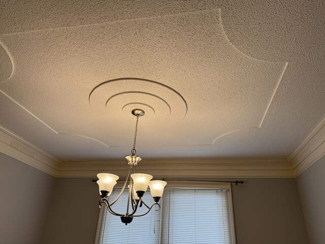 interior details featuring crown molding, a textured ceiling, and an inviting chandelier