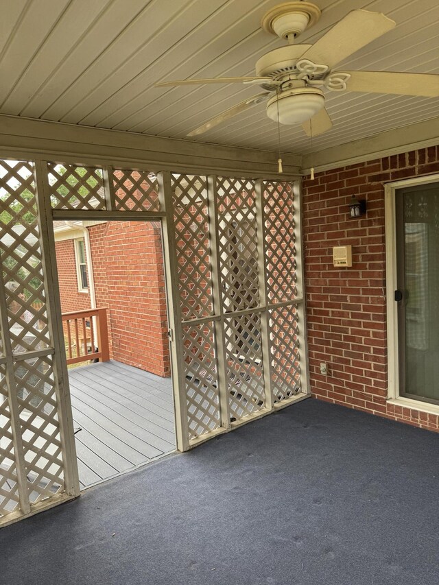 wooden terrace featuring a ceiling fan