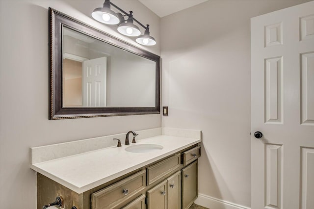 bathroom with baseboards and vanity