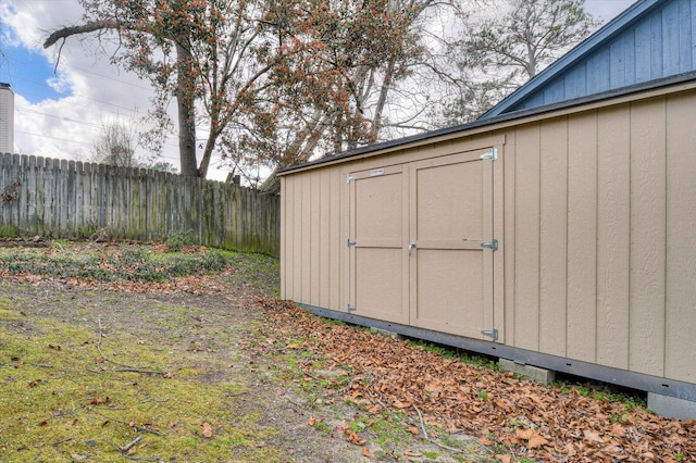 view of shed featuring fence