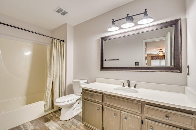 full bathroom featuring visible vents, toilet, shower / bath combo, vanity, and wood finished floors