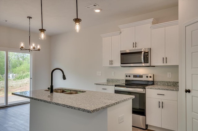 kitchen with light stone counters, visible vents, appliances with stainless steel finishes, a kitchen island with sink, and a sink
