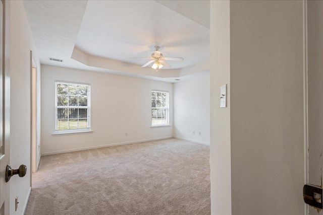 2071 Lake Forest Dr, Grovetown, GA 30813 - spare room featuring carpet floors, ceiling fan, plenty of natural light, and a tray ceiling