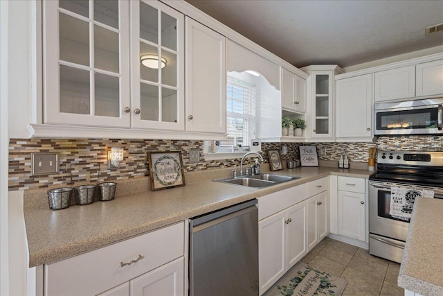 2071 Lake Forest Dr, Grovetown, GA 30813 - kitchen with appliances with stainless steel finishes, white cabinets, light countertops, and light tile patterned floors