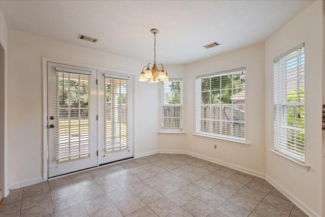 2071 Lake Forest Dr, Grovetown, GA 30813 - unfurnished dining area with a chandelier and light tile patterned floors
